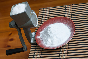 Grinding of sugar to the powder.
