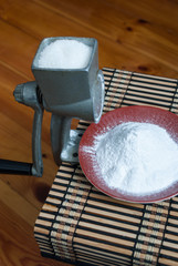 Grinding of sugar to the powder.