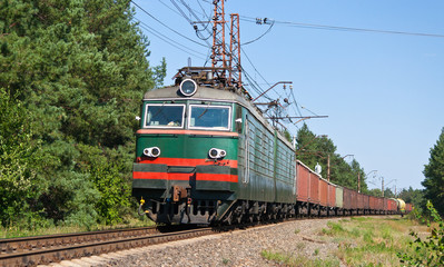 Fototapeta premium Freight train hauled by electric locomotive