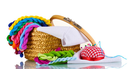 bright threads for needlework and fabric in a wicker basket