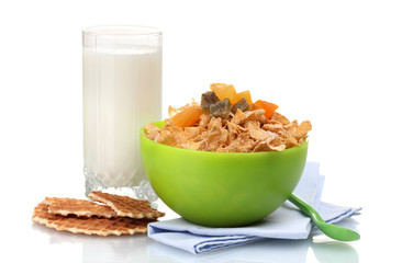 tasty cornflakes in green bowl and glass of milk isolated