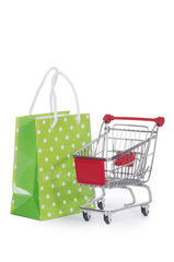 The shopping cart and bags isolated on white