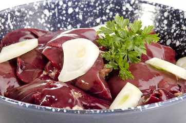 chicken liver with onion slices in a pan
