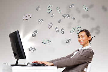Businesswoman  at workplace and money symbols