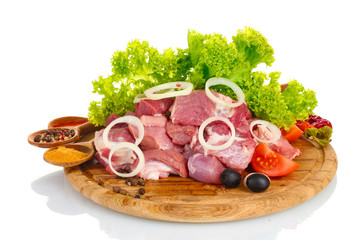 Pieces of raw meat and vegetables
