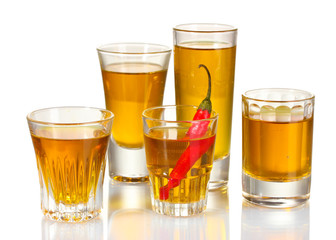 glasses of pepper vodka and red chili pepper isolated on white
