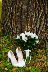 close up of wedding bouquet with shoes