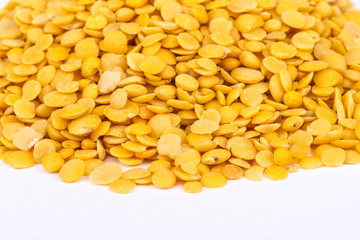 Yellow lentils isolated on white background.Macro shot