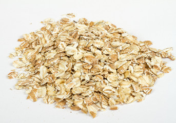 Heap of dry rolled oats isolated on white background