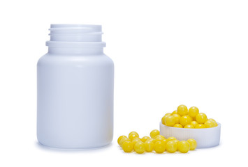 yellow pills and a plastic bottle