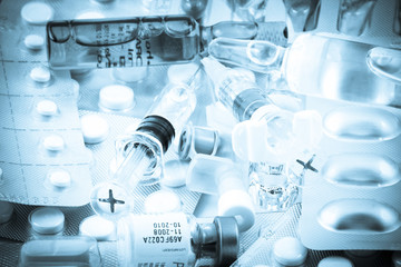 Pills of many shapes and colors grouped together