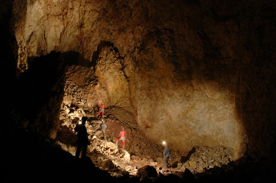 Monumental cave hall with cavers exploring it