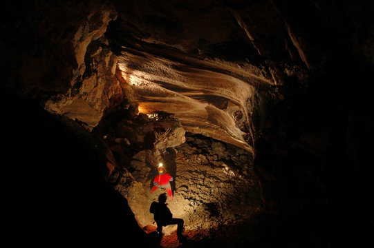 Cave explorers, speleologists exploring the underground