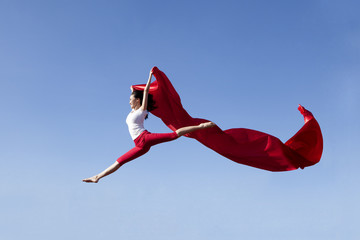 Asian woman jumping expressing freedom © Creativa Images