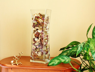 Glass vase filled with flower petals