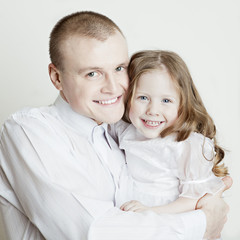 Portrait of beautiful smiling family: father and daughter