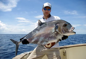 Foto op Canvas Happy  fisherman holding a trevally jack © sablin