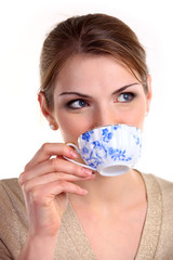 Beautiful girl with cup of tea, isolated over white