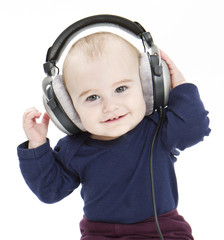 young child with ear-phones listening to music