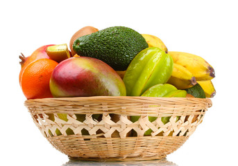 Assortment of exotic fruits in basket isolated on white
