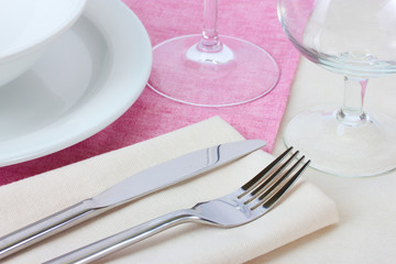 Table setting with fork, knife, plates and napkin