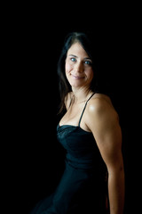 Naklejka premium Pretty woman in black smiling at the camera