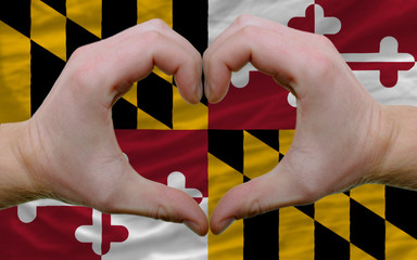 over american state flag of maryland showed heart and love gestu