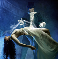 Magician performs magic with beauty girls in air