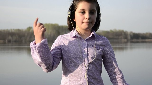 young girl is singing and dancing