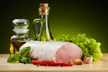 Raw pork on cutting board and vegetables