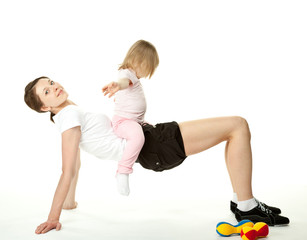 Fototapeta na wymiar Young woman and her daughter doing sport exercises