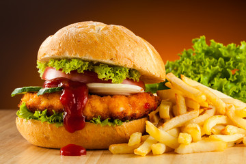Big hamburger, French fries and vegetables