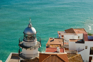 Lighthouse over the rooftops in a mediterranean village