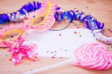 carnival mask and confetti with blank card to insert text