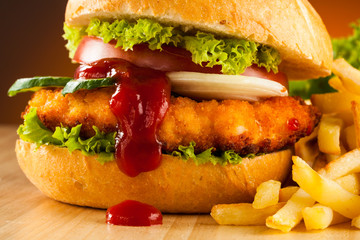 Big hamburger, French fries and vegetables