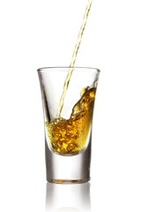 Pouring pepper vodka, into glass isolated on white