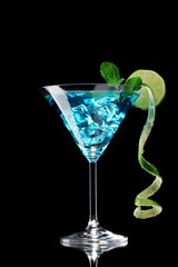 Blue cocktail in glass on black background