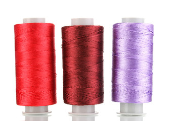 Three bobbin thread isolated on white