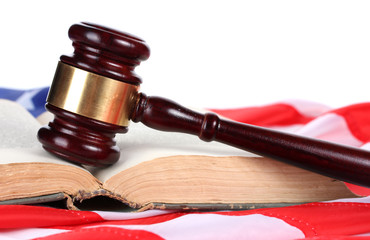 judge gavel and book on american flag on white background