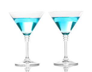 Blue cocktail in martini glasses isolated on white