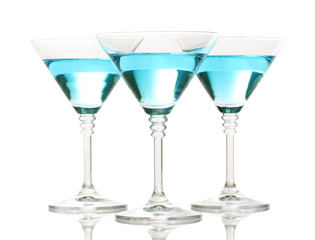 Blue cocktail in martini glasses isolated on white