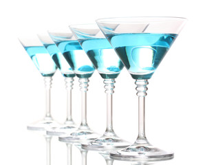 Blue cocktail in martini glasses isolated on white