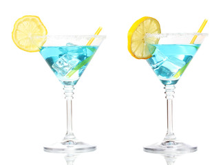 Blue cocktail in martini glasses isolated on white