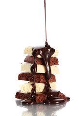 Slices of milk and white chocolate bar poured chocolate isolated