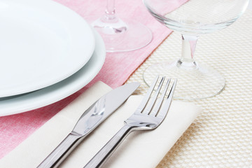 Table setting with fork, knife, plates, and napkin