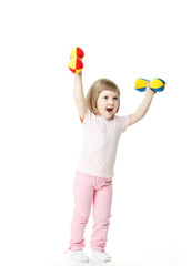 Little baby girl doing sport exercises with toy dumbbells