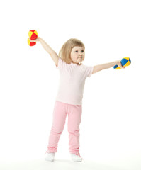 Funny little baby girl doing sport exercises with toy dumbbells