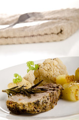 roast pork with fried potatoes and cauliflower