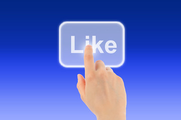 Woman hand uses like button on blue background
