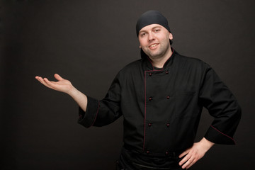 chef in black uniforms gesture inviting enter